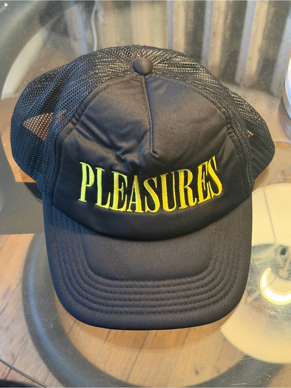 PLEASURES Black Trucker Hat with Yellow Logo